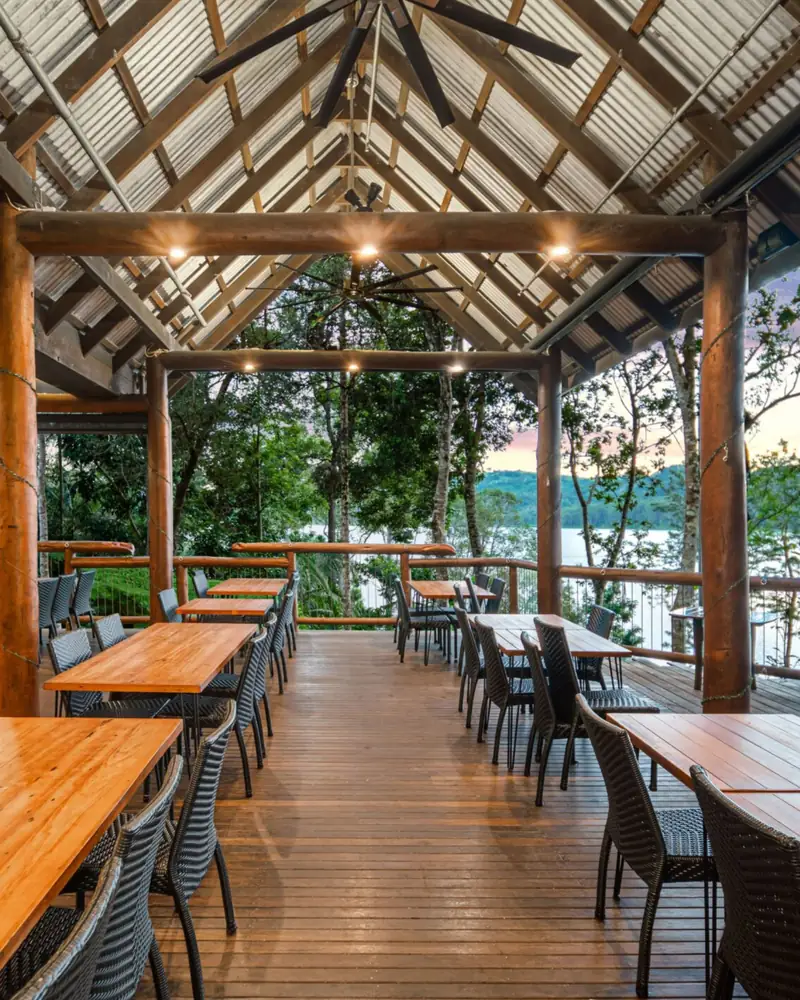 Long timber tables under the open roof of Dining on the Deck