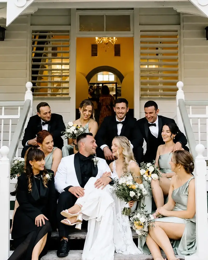 A bridal party on the steps of the Lakehouse at Secrets on the Lake