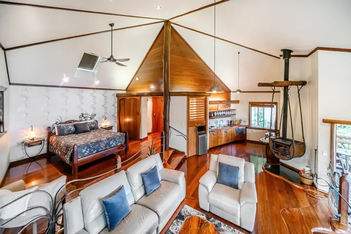 Platypus penthouse bedroom with timber features and a suspended fireplace