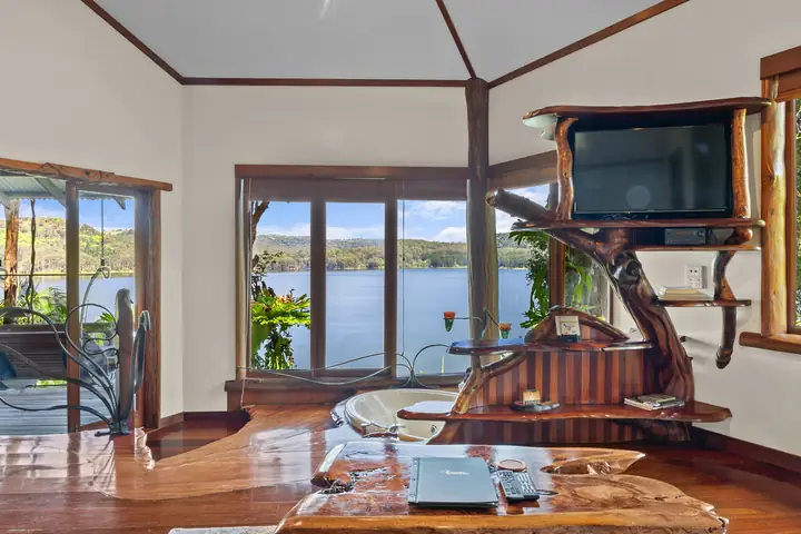 The Secrets Premium Penthouse bedroom with a sculpted timber bed