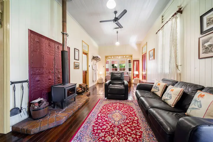 Inside Whistlestop, a heritage cabin with timber floors and a lounge